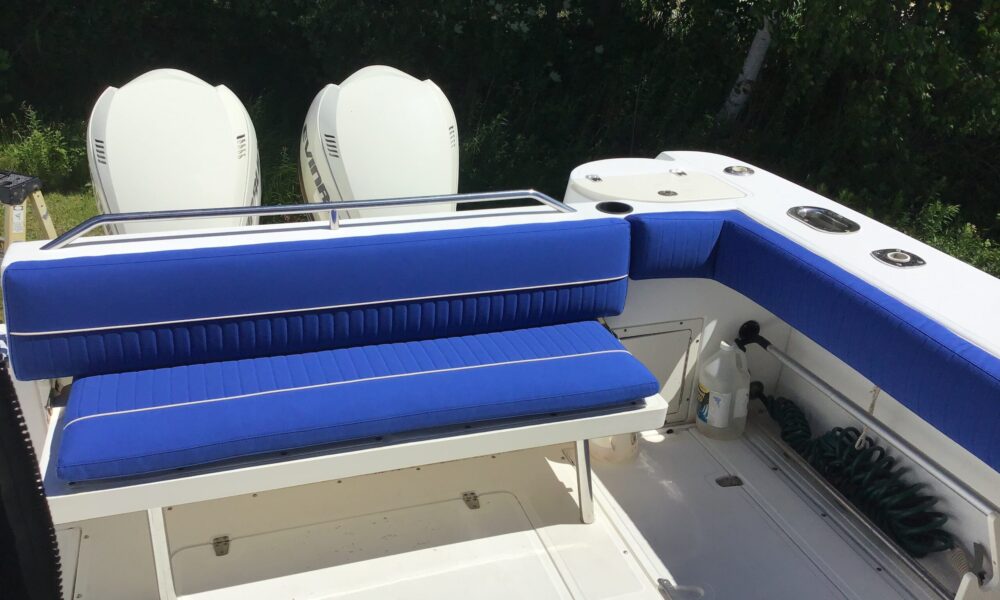 Custom hand channeled seating on a Boston Whaler made with Sunbrella® Mediterranean Blue and Parchment for the piping is a beautiful color combination