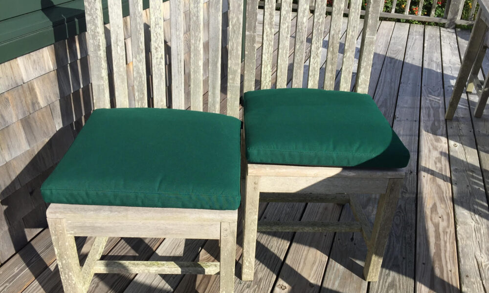 Outdoor cushions made with Sunbrella® Forest Green and reticulated foam are perfect a beach house
